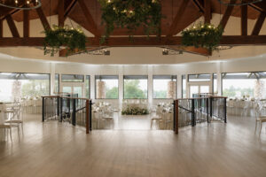 Reception space shot of dinner set up at the Oaks at Plum Creek. Clean, timeless decoration with touches of whites and greens.