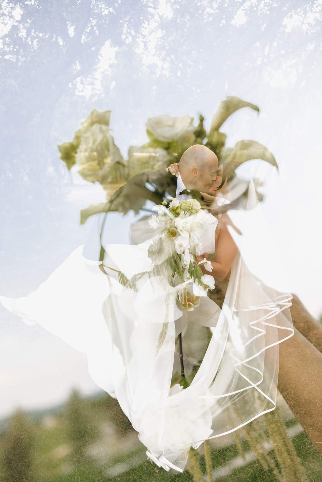 Double exposure of a wedding flower and couples kissing.