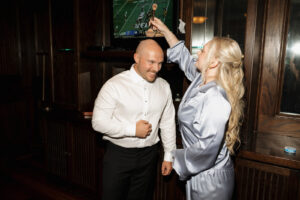 Grooms sister helps him get ready.